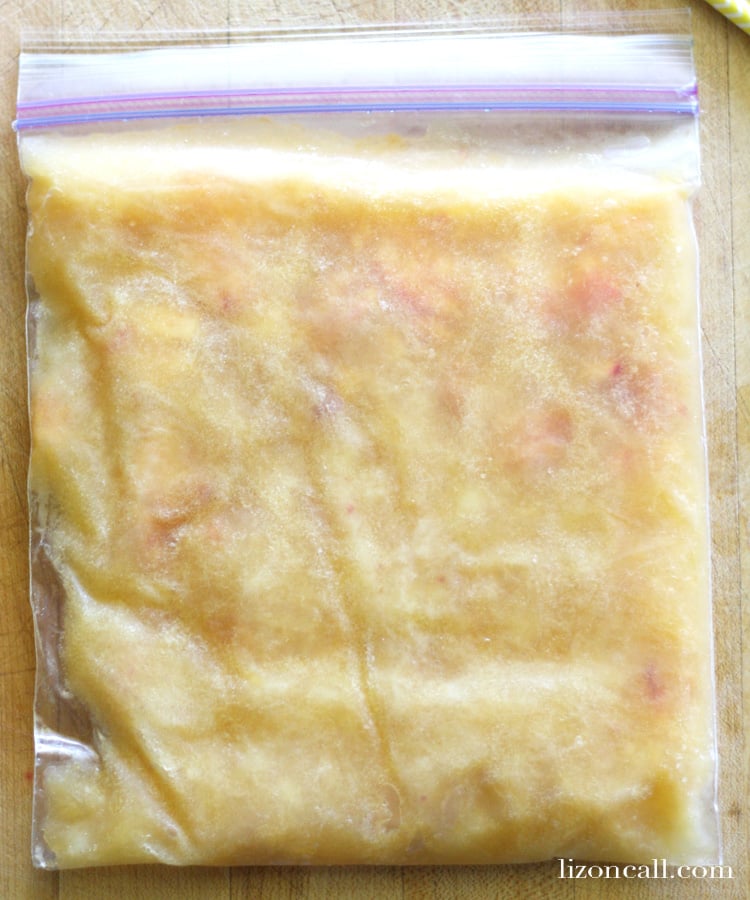 freezer bag filled with ingredients to make a peach slush punch recipe