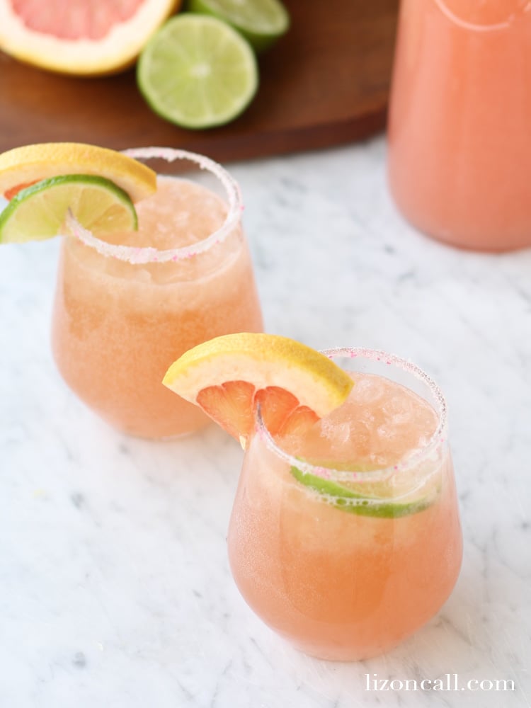 glasses of sparkling grapefruit juice punch garnished with fresh fruit slices